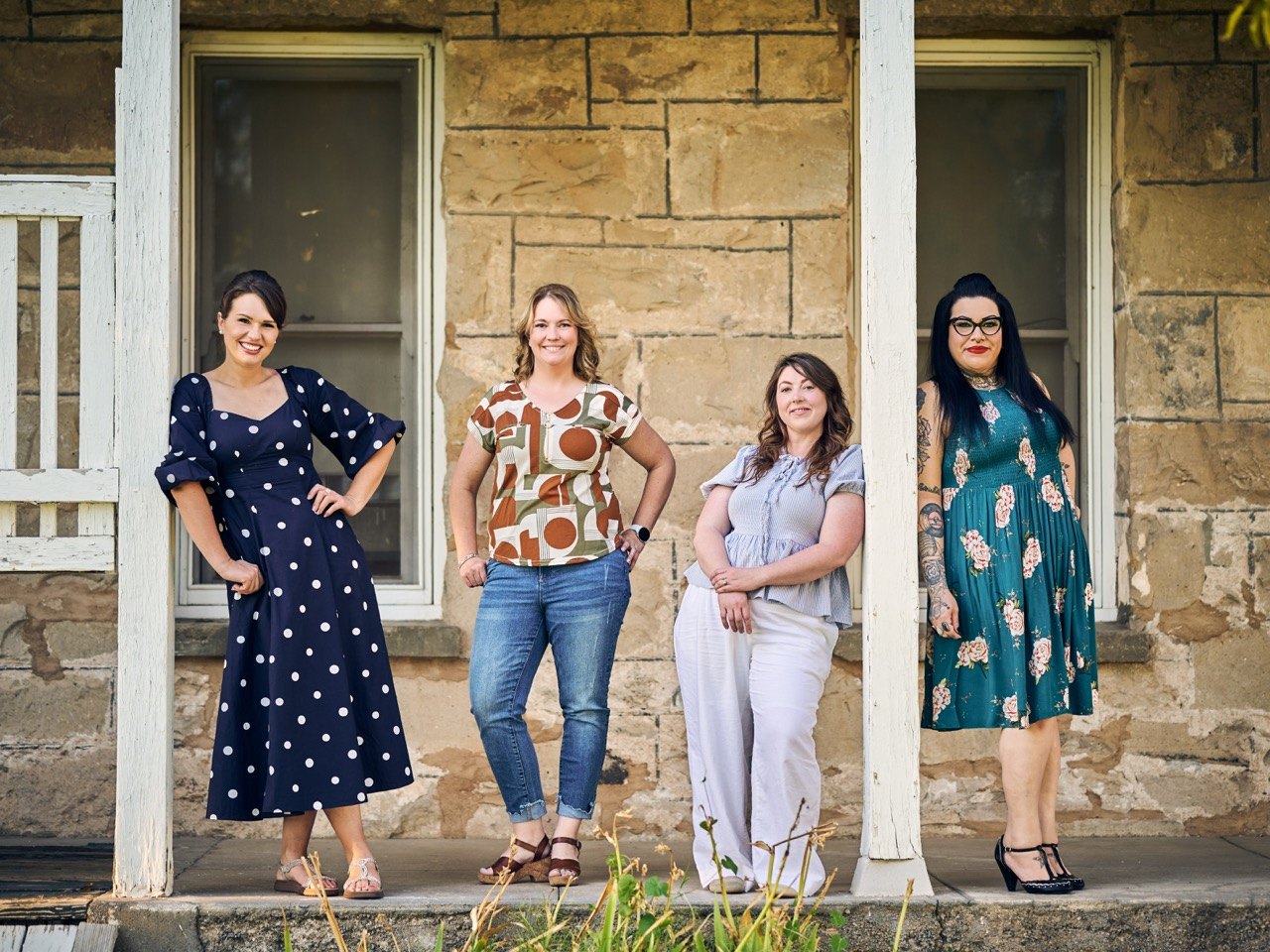 Four of the Liberating Love team on a stone porch